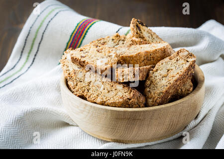 Cantuccini cookies in wooden plate on a wooden table Stock Photo