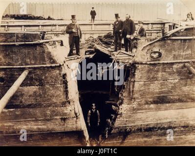 Wolf, mail paddle steamer in dry dock, man stands in the'v' shaped split in its starboard bow Stock Photo