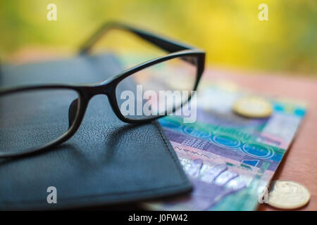 Kazakhstan money, glasses and wallet. Currency of tenge, close-up. Stock Photo