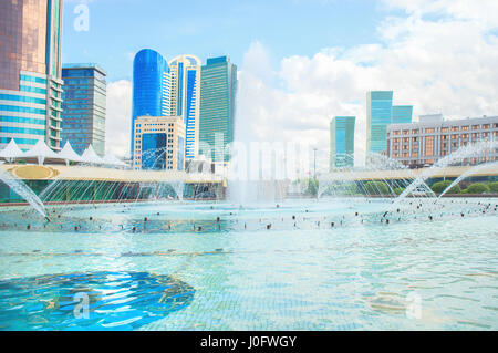 Fountains in the city of Astana. Against the backdrop of the building and business centers in the capital of Kazakhstan. Stock Photo