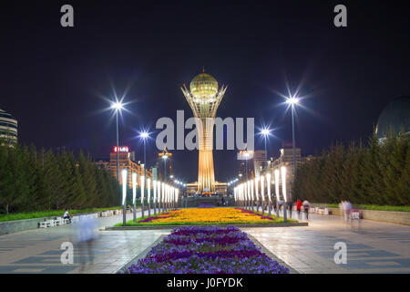 The Baiterek monument in Astana, capital of Kazakhstan. On the Central square people walk and relax in night. Stock Photo