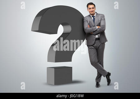 Businessman next to the giant question mark Stock Photo