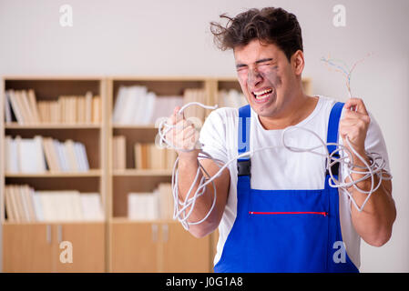 Funny Man doing electrical repairs at home Stock Photo
