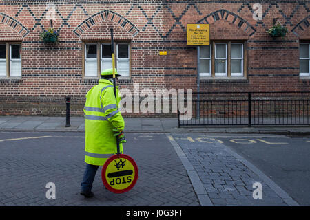 Eton, UK. 2nd March, 2017. A crossing guard, or lollipop woman, in front of Eton Porny Church of England First School. Stock Photo