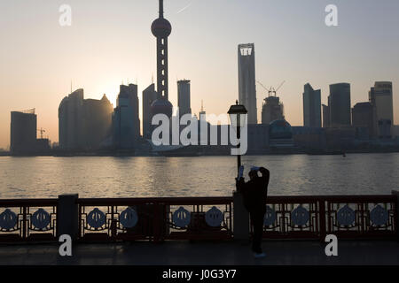 Man doing morning exercises & view to Pudong from The Bund, Shanghai, China Stock Photo