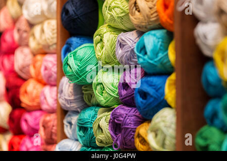 shelves with colorful wool and yarn in a knitting shop Stock Photo