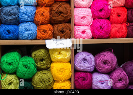 shelves with colorful yarn balls in store Stock Photo