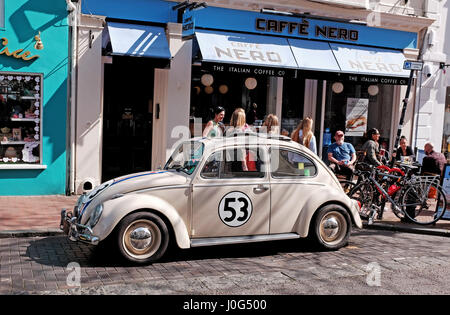 Old Volkswagen Beetle car painted in same colours as from the famous film Herbie spotted parked in Brighton UK Stock Photo