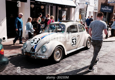 Old Volkswagen Beetle car painted in same colours as from the famous film Herbie spotted parked in Brighton UK Stock Photo