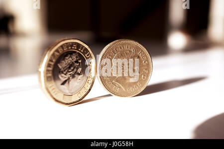 The new pound coin (left) and old pound coin British money sterling Stock Photo