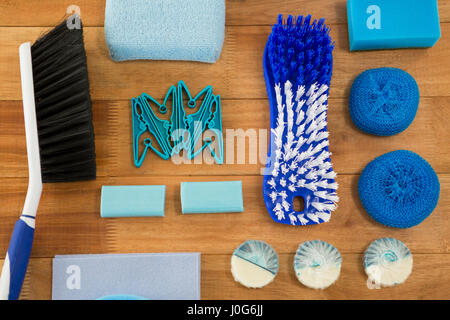 Overhead view of brushes and sponge with soaps on wooden table Stock Photo