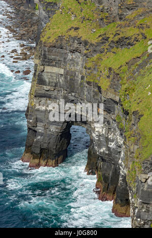 Rock arch at the foot of the Cliffs of Moher, County Clare, Ireland Stock Photo