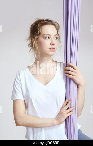 Yoga. Aerial yoga Yoga air. Yoga on the horn. Yoga exercises. Yoga positions. Yoga. Antigravity yoga.A woman is practicing yoga on a hose, aerial yoga Stock Photo