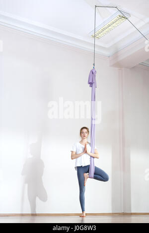 Yoga. Aerial yoga Yoga air. Yoga on the horn. Yoga exercises. Yoga positions. Yoga. Antigravity yoga.A woman is practicing yoga on a hose, aerial yoga Stock Photo