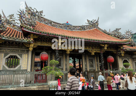 A lot of people at the ornate Mengjia Longshan Temple in Taipei, Taiwan. Stock Photo