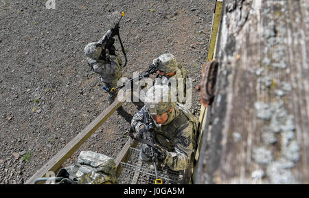 Tech. Sgt. Christian Gomez, 569th U.S. Forces Police Squadron Bravo Flight chief, and other students of the 435th Security Forces Squadron’s Ground Combat Readiness Training Center’s Security Operations Course climb stairs to search the top floor of a building during the urban operations portion of the course on U.S. Army Garrison Baumholder, Germany, April 4, 2017. During the urban ops portion the course, the cadres used blank rounds and flash bangs to simulate an attack upon the students. Airmen assigned to the 86th SFS, 422nd SFS, 100th SFS, and 569th USFPS participated in the course. (U.S. Stock Photo