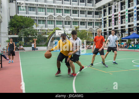 170408-N-EW322-072  HONG KONG (April 8, 2017) Sailors and Marines assigned to amphibious assault ship USS Makin Island (LHD 8) and the embarked 11th Marine Expeditionary Unit (MEU) play basketball with ELCHK Yuen Long Lutheran Secondary School students as part of a scheduled port visit. Makin Island, with the embarked 11th MEU, is in Hong Kong to experience the city's rich culture and history as part of ongoing operations in the Indo-Asia-Pacific region. (U.S. Navy photo by Mass Communication Specialist 3rd Class Clark Lane) Stock Photo