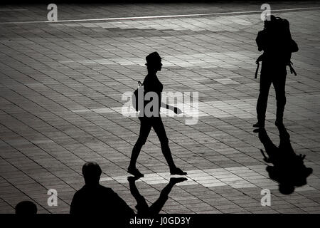 Silhouette of a walking woman in a hat Stock Photo