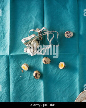 still life on teal blue fabric with quail eggs Stock Photo