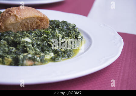 White dish with stew prepared for eating Stock Photo