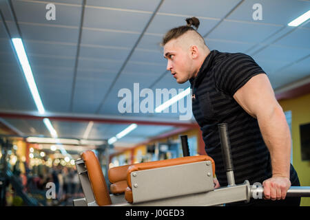 Focused man doing dips in the gym Stock Photo