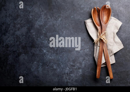 Cooking spoons over towel on stone table. Top view with space for your text Stock Photo