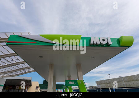 Exterior of an MOL gas station. Gasoline pumps and cars refueling in a ...