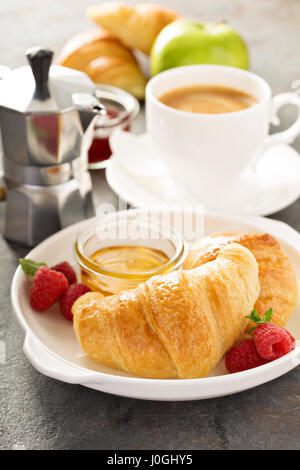 Freshly baked croissants with honey and jam Stock Photo