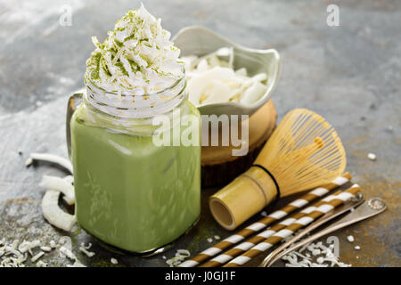 Iced matcha latte with coconut cream Stock Photo