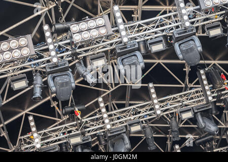 multiple spotlights on a festival stage lighting rig - equipment identifications removed Stock Photo