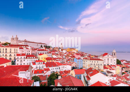 View of Alfama, the oldest district of the Old Town, with Monastery of Sao Vicente de Fora, Church of Saint Stephen and National Pantheon at scenic su Stock Photo