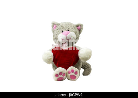 toy cat sitting holding a heart on a white background.Valentine's day Stock Photo