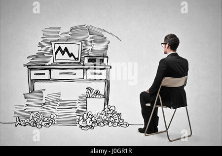 Businessman in front of drawn desk Stock Photo