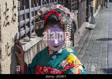 Young beautiful Japanese women called Maiko wear a traditional dress called Kimono at Gion, Kyoto, Japan. Stock Photo