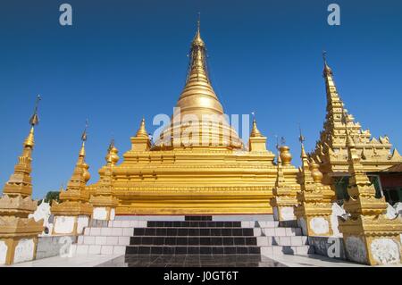 Golden Sandamuni Pagoda with row of white pagodas. Amazing architecture of Buddhist Temples at Mandalay. Stock Photo