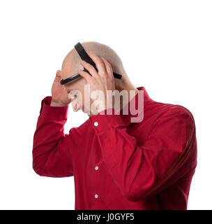 Young man puts on head headset EEG (electroencephalography). Isolated on white background. Stock Photo