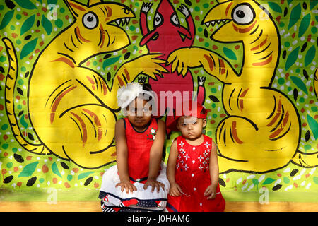 Dhaka, Bangladesh. 14th Apr, 2017. Children sit in front of a painted wall at the Fine Arts Faculty of Dhaka University as the pert of the Bangla new year celebration. Credit: Muhammad Mostafigur Rahman/Alamy Live News Stock Photo