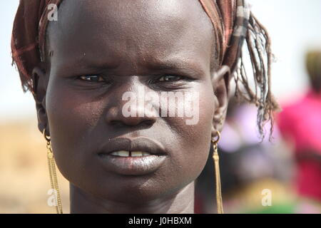 Ganyliel, South Sudan. 24th Mar, 2017. Maria Nyamuoka, mother of three children, awaits the monthly distribution of relief supplies in Ganyliel, South Sudan, 24 March 2017. The area is located in the South Sudanese state of Unity, the region most affected by famine in the country. Photo: Jürgen Bätz/dpa/Alamy Live News Stock Photo
