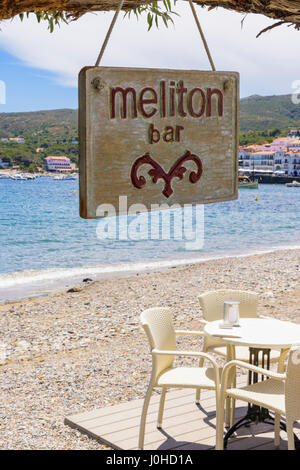 Focus on Meliton Bar sign hanging from a tree branch at a beach side cafe bar in Cadaques, Catalonia, Spain Stock Photo