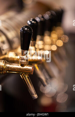 Lot of vintage Golden beer taps at the bar Stock Photo