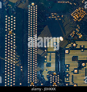 detail of the back of a motherboard. Circuits and welds Stock Photo
