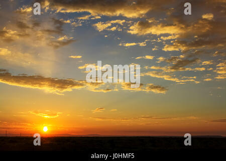 A sunset in the American Southwest with cloudy sky. Stock Photo