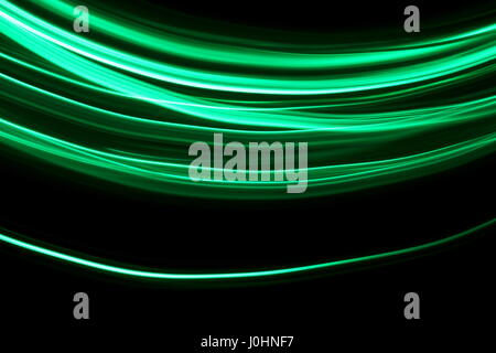 Green light painting photography, waves on a black background Stock Photo