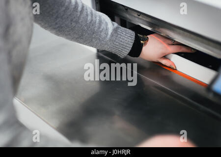 Paper Cutting Guillotine Machine in Use Stock Photo