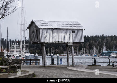 The LightShed sculpture by Liz Magor sits on Vancouver's seawall. Maybe tiny houses on stilts is the answer to Vancouver's housing crisis. Stock Photo