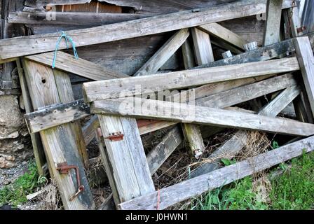 Old gates leaning on a wall. Stock Photo