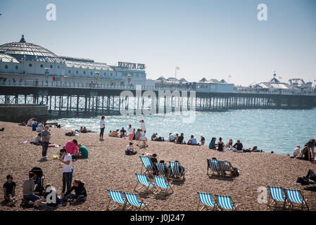 April, 9th 2017, Brighton, UK. People enjoy a sunny day at Brighton beach Stock Photo