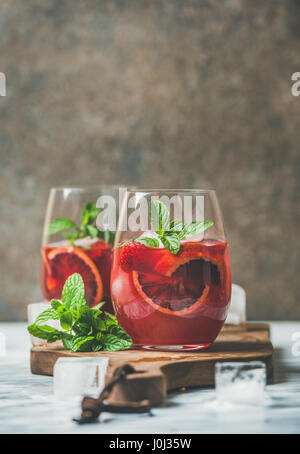 Blood orange and strawberry summer Sangria in glasses, copy space Stock Photo