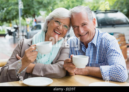 Portrait of senior couple having coffee in outdoor cafÃƒÂ© Stock Photo