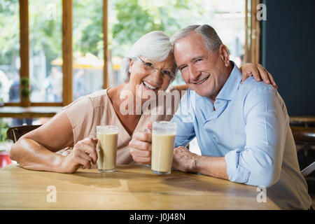 Portrait of happy senior couple having cold coffee in cafÃƒÂ© Stock Photo
